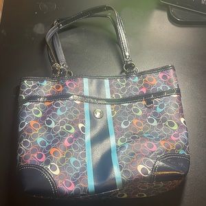 a multicolor coach shoulder bag